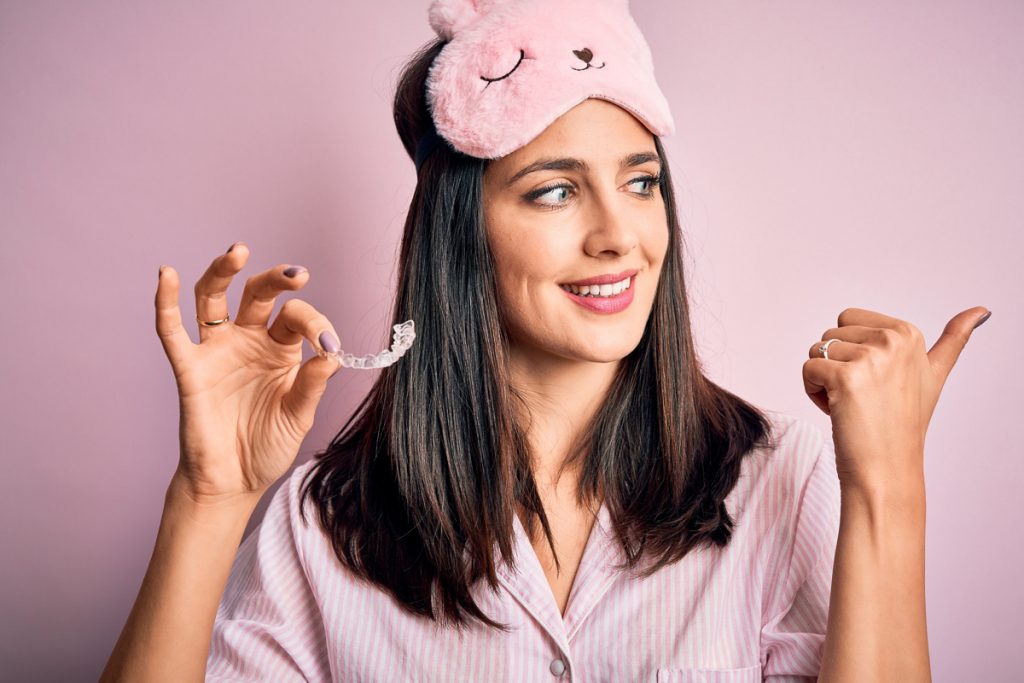 Woman holding aligner in hand - Smileunion experience