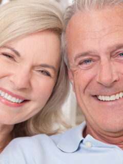 Two seniors smiling - Metal Retainer after Braces