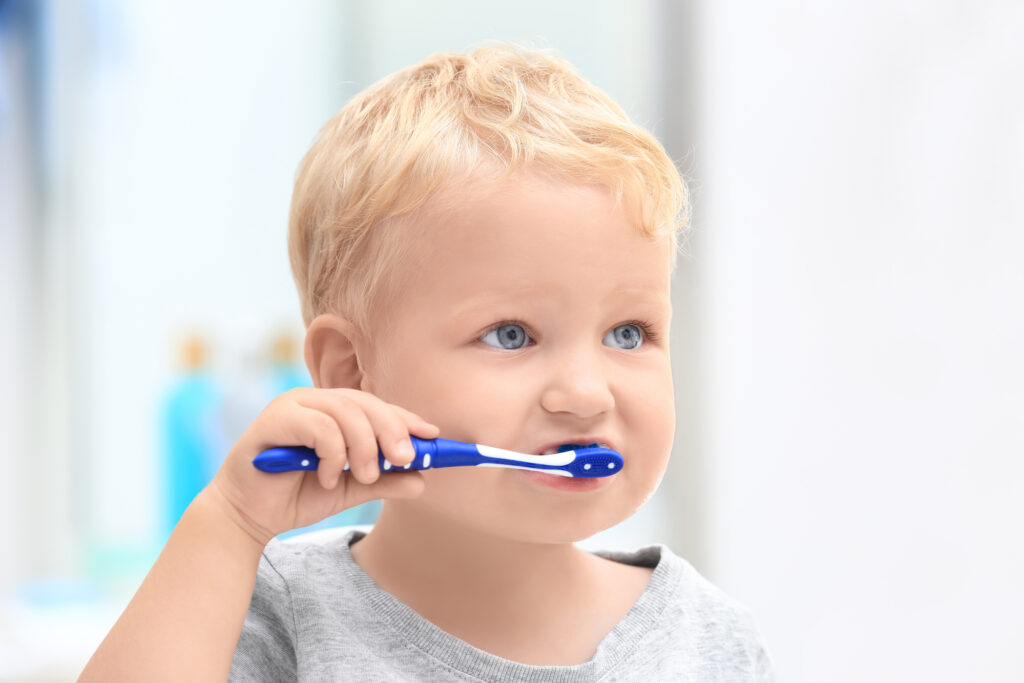 Child brushes his milk teeth